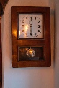 a clock on a wall on a wall at Casa Baroca in Sighişoara