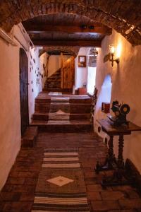 a hallway of a house with stairs and a stair case at Casa Baroca in Sighişoara