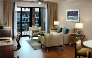 a living room with a couch and chairs at Naples Bay Resort and Marina in Naples