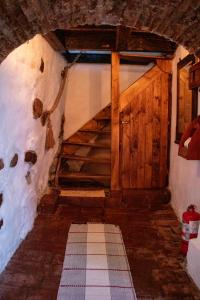 an attic room with wooden stairs in a building at Casa Baroca in Sighişoara