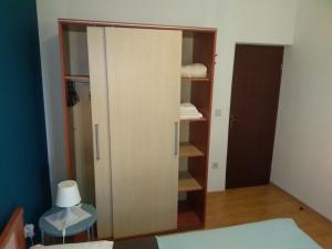 a cupboard in a room with a lamp at Apartment Gogo in Umag