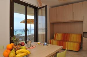 a kitchen with a table with fruit on it at Il Mare di Alida in Alghero