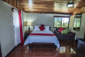 a bedroom with a bed and a couch at Mar Inn Costa Rica in Monteverde Costa Rica