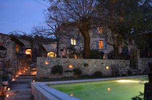 a house with a swimming pool in front of a house at Les Rosées in Mougins