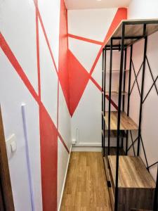a staircase in a room with a red and white wall at Scandi-house in Marly-la-Ville