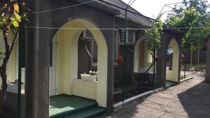 a building with arches and plants in a yard at House of Grace in Reni