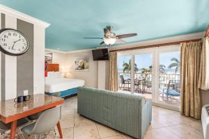 a hotel room with a bed and a clock at Plaza Beach Hotel - Beachfront Resort in St Pete Beach