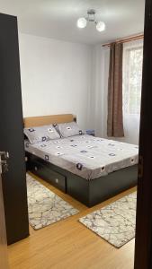 a bedroom with a bed and a window at Arician full service in Ocna Şugatag