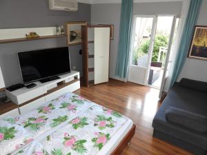a living room with a flat screen tv and a couch at Apartments Lončar in Gradac