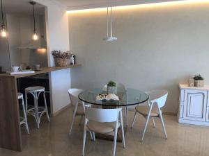 a dining room with a glass table and chairs at Mediterraneo Sitges in Sitges
