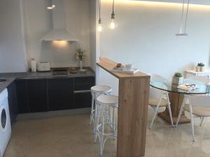 a kitchen with a counter and a table and chairs at Mediterraneo Sitges in Sitges