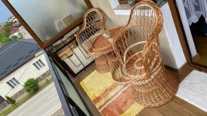 two wicker chairs sitting on top of a balcony at Arician full service in Ocna Şugatag