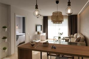 a living room with a dining table and a living room at Mediterraneo Sitges in Sitges
