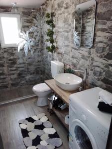 a bathroom with a toilet sink and a washing machine at Luštica Apartments in Luštica
