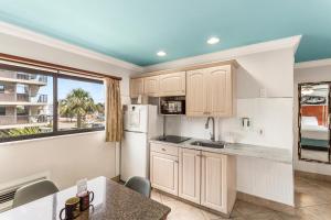 a kitchen with a refrigerator, stove, sink and dishwasher at Plaza Beach Hotel - Beachfront Resort in St Pete Beach