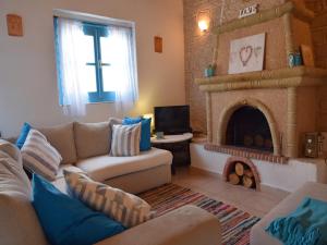 a living room with a couch and a fireplace at Villa Pavlina Gennadi in Gennadi