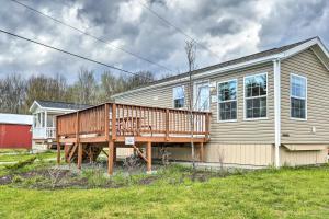 a house with a deck on the side of it at Idyllic Poconos Cottage with Deck and Community Perks! in Pleasant Mount