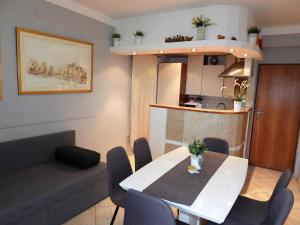 a living room with a table and chairs and a kitchen at Apartments Lončar in Gradac