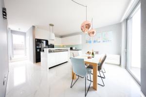 a kitchen with a dining room table and chairs at CAISA - AMBER 20m from the sea in Zadar