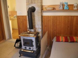 a wood stove in a room with a bed at Peaceful Holiday Home in Hol n with Garden in Prachov