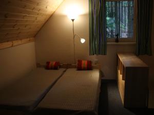 Cama en habitación con lámpara y ventana en Peaceful Holiday Home in Hol n with Garden, en Prachov