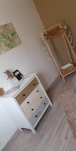 a room with a white dresser and a bed at Le cosy de sarah in Bordeaux-Saint-Clair