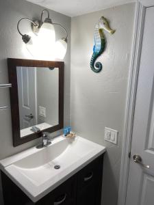 a bathroom with a sink and a mirror at Hideaway Village in Fort Myers Beach