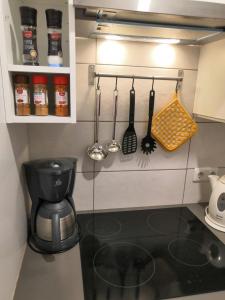 a small kitchen with a coffee pot and utensils at Gästehaus Kayetan in Klais