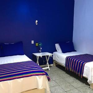 Voodi või voodid majutusasutuse Hostal Tlaquepaque toas