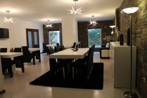 a dining room with tables and chairs in a room at Casa de Vale Benfeito - Turismo Rural in Macedo de Cavaleiros