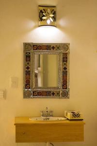 a bathroom with a sink and a mirror on the wall at Hostal Tlaquepaque in Guadalajara