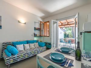 a living room with a couch and a table at Sardinia SPA Apartment in Geremèas