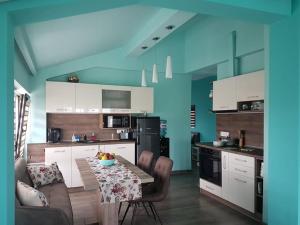 a kitchen with a table and chairs in a room at Deluxe Aquamarine in Ahtopol