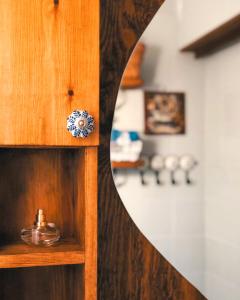a wooden cabinet with a mirror in a room at Elia's House Traditional & Cozy in Kalyves