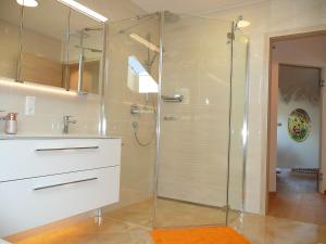a glass shower in a bathroom with a sink at Alpenstern Ferienwohnung in Pfronten