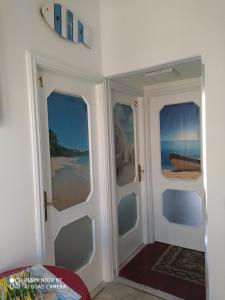 a room with two doors leading to the beach at Casa privata vacanze Relax piazza Maria Anania vico n4 in Crotone