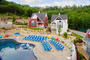 an aerial view of a pool with lounge chairs and a house at Stormy Point Village Lakeside in Branson