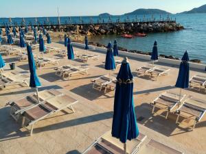 a group of chairs and umbrellas on a beach at Ca di Ale in Lerici