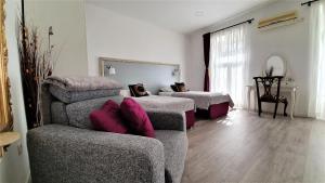 a living room with two beds and a couch at Apartment Cont in Rijeka