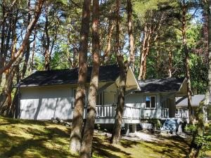 a house in the woods with trees at Mistral przy plaży Domki całoroczne in Ustka