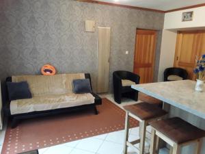 a living room with a couch and a table at CHAMBRES D'HOTES au vieux moulin entre Sarreguemine et Bitche in Rahling +7 photos
