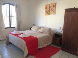 1 dormitorio con 1 cama con manta roja en Cálido apartamento en Salta