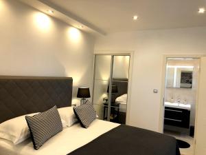 a bedroom with a bed and a bathroom with a sink at Apartments Antoana in Hvar