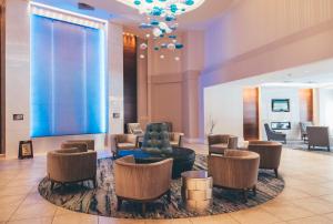 a lobby with a blue couch and chairs at Temple Gardens Hotel & Spa in Moose Jaw