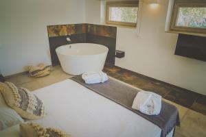 a bathroom with a tub and towels on a floor at Casa Ziazì Room e Nature in Monopoli