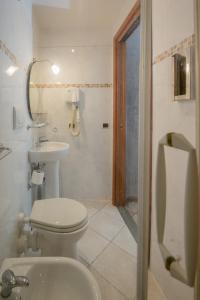 a bathroom with a toilet and a sink at Hotel Angelica " Stazione Santa Maria Novella " in Florence