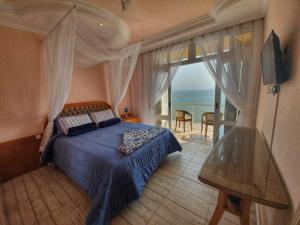 a bedroom with a bed and a view of the ocean at Pousada Pedra das Tartarugas in São Francisco do Sul