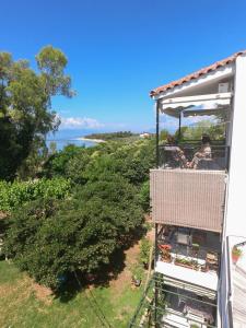 people riding on a gondola in a house overlooking the ocean at Heracles Guesthouse in Rovies