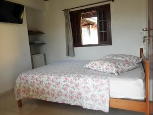 A bed or beds in a room at Pousada da Geisa
