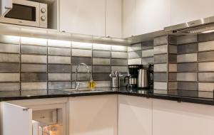 a kitchen with stainless steel appliances and counter tops at CADET Residence in Paris